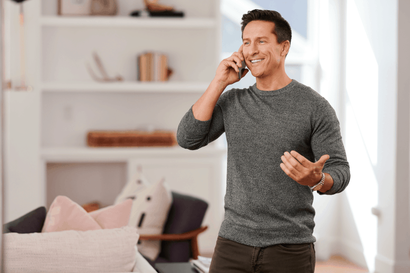 man talking on cell phone in his home