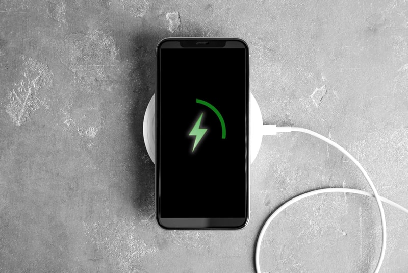 smartphone charging on a wireless charger-min
