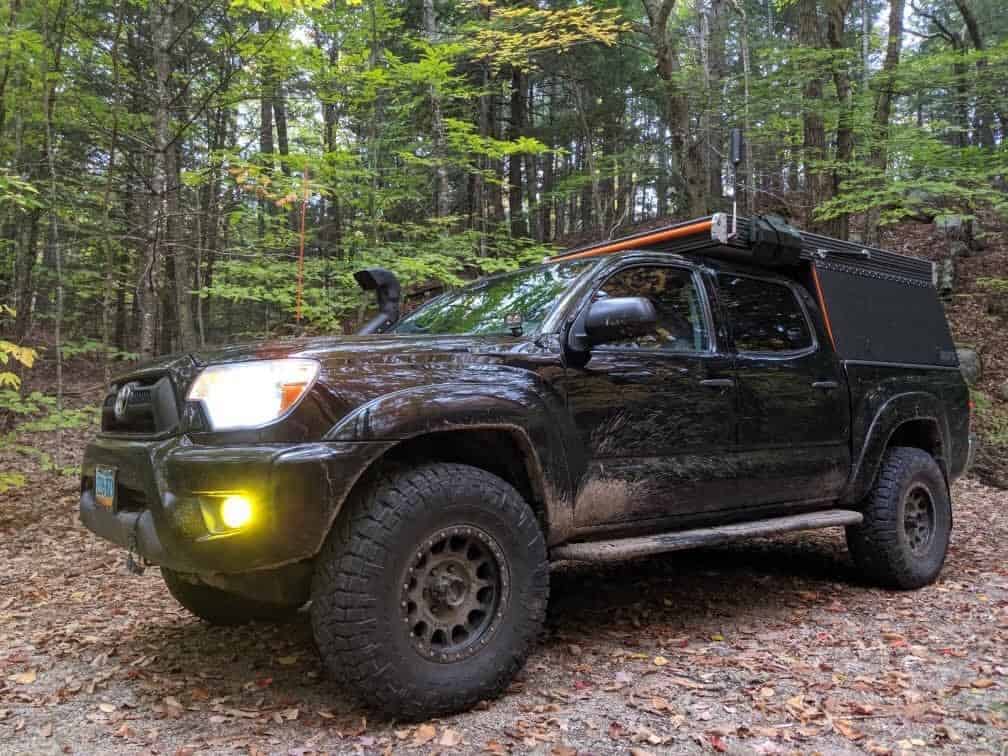 image of overland truck in the woods
