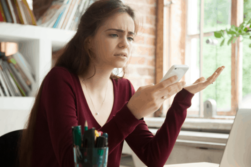 Young woman frustrated that phone keeps dropping calls