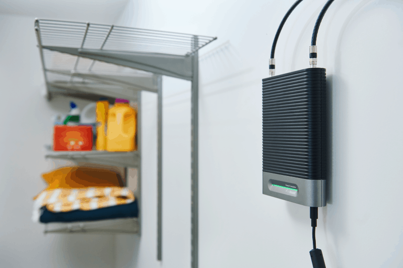 an indoor cell phone signal booster hangs on a wall